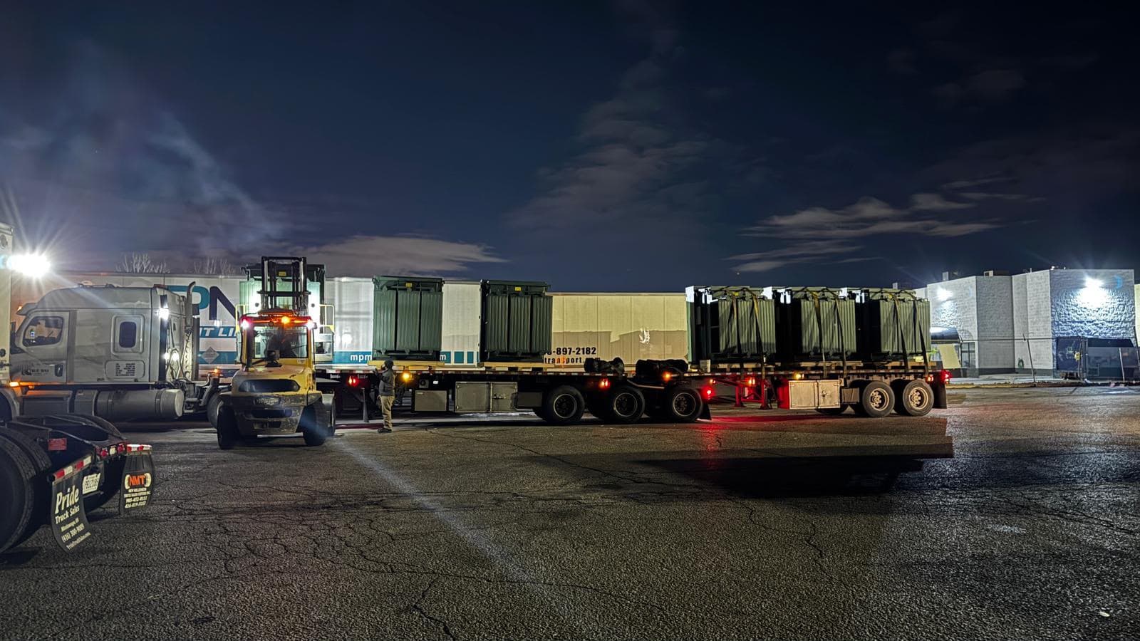 Four replacement transformers staged on trailers for overnight emergency dispatch